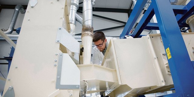 «Agrar Dirigent» Emanuel Schütt begutachtet die neue Anlage, mit der das Unternehmen Hanfnüsse und andere Ölsaaten reinigen und schälen kann.(Bild Alpen Pionier)