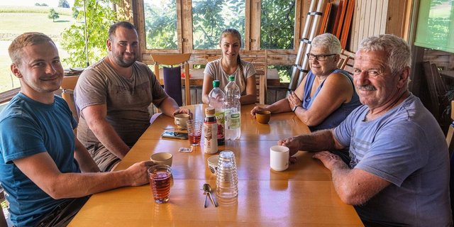 Familie Duperrex sitzt mit Kati Fábián und Jan Burkhard beim Frühstück.