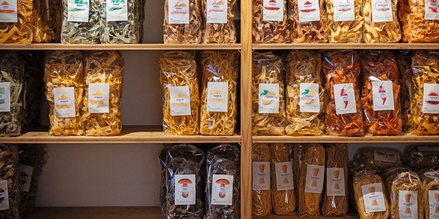 Verschiedene Sorten Teigwaren stehen im Regal des Hofladens.