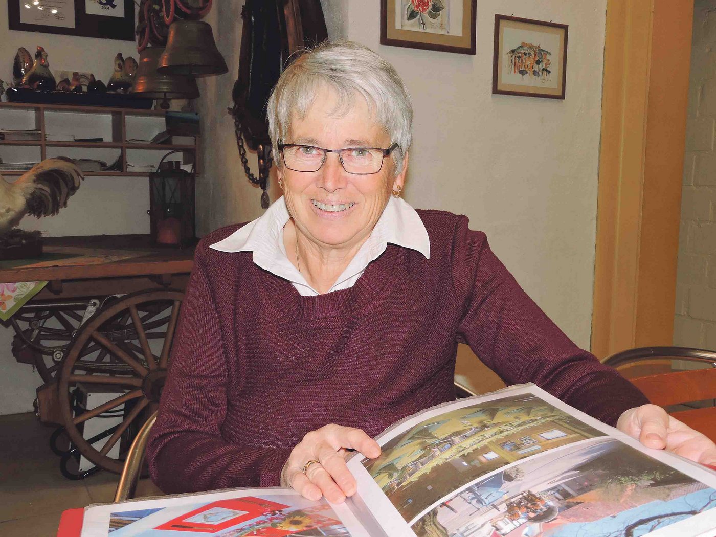 Lilli Gross blättert in ihrem Ordner mit den  Fotos der Tischdekorationen, mit denen sie die Fest-Tafeln schön herrichtet. Immer wieder hat sie neue, kreative Ideen,   obwohl sie schon seit langem in der Gästebewirtung tätig ist. (Bild Barbara Heiniger)