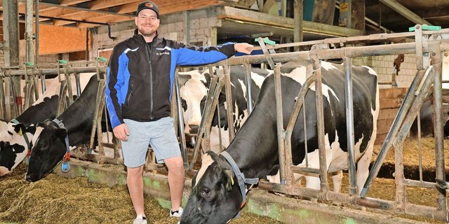 Pascal Krebs neben einer seiner 75 Milchkühe. Im Stall hält er Holstein, Red Holstein und Brown Swiss. Das Melken übernimmt ein Melkroboter, die Milchleistung beträgt 12 000 kg Milch pro Kuh und Jahr.
