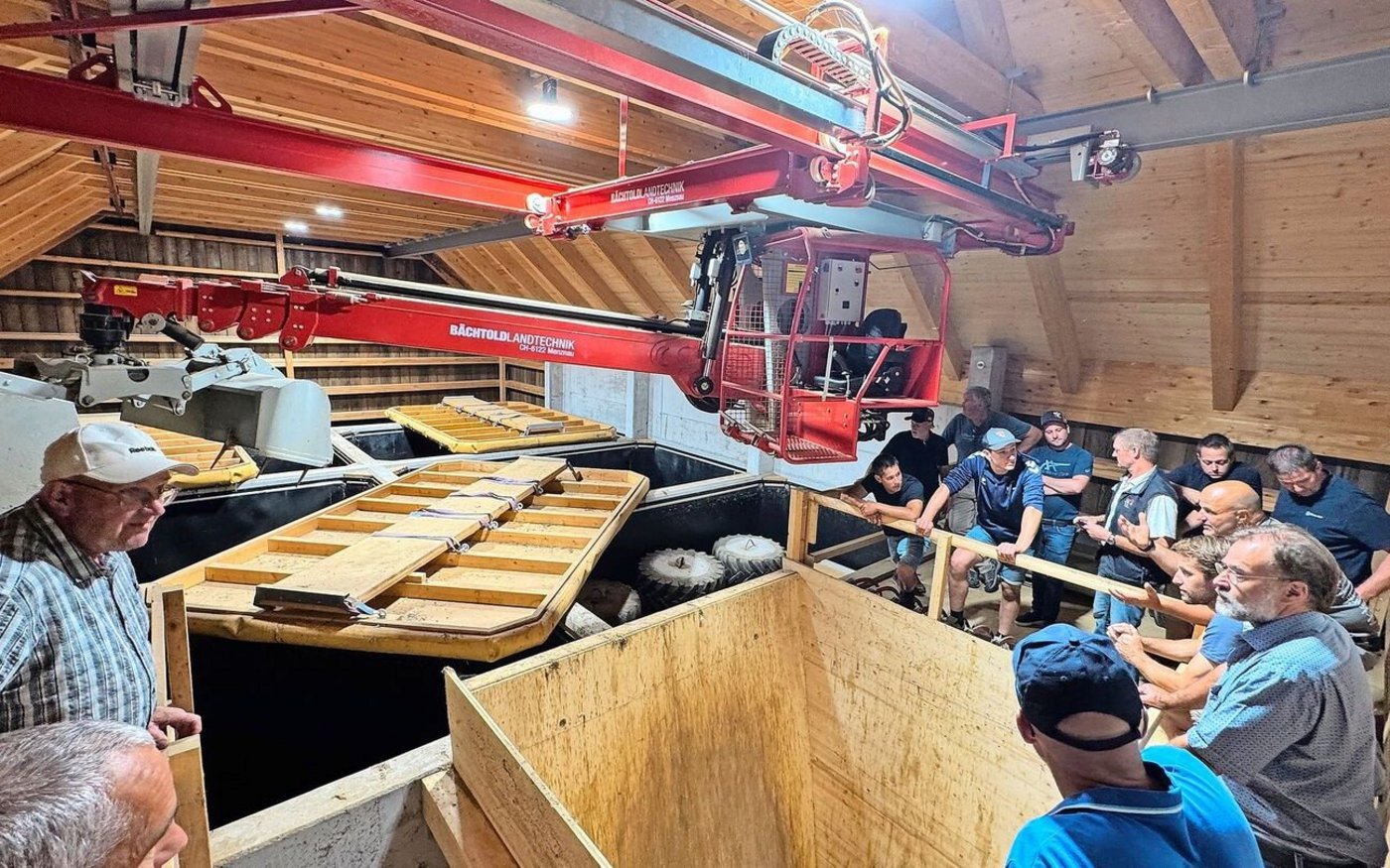 Mit einem Kran mit Teleskopgreifarm wird die Silage aus den mehr als zwölf Meter tiefen Silo-Kompartimenten entnommen.