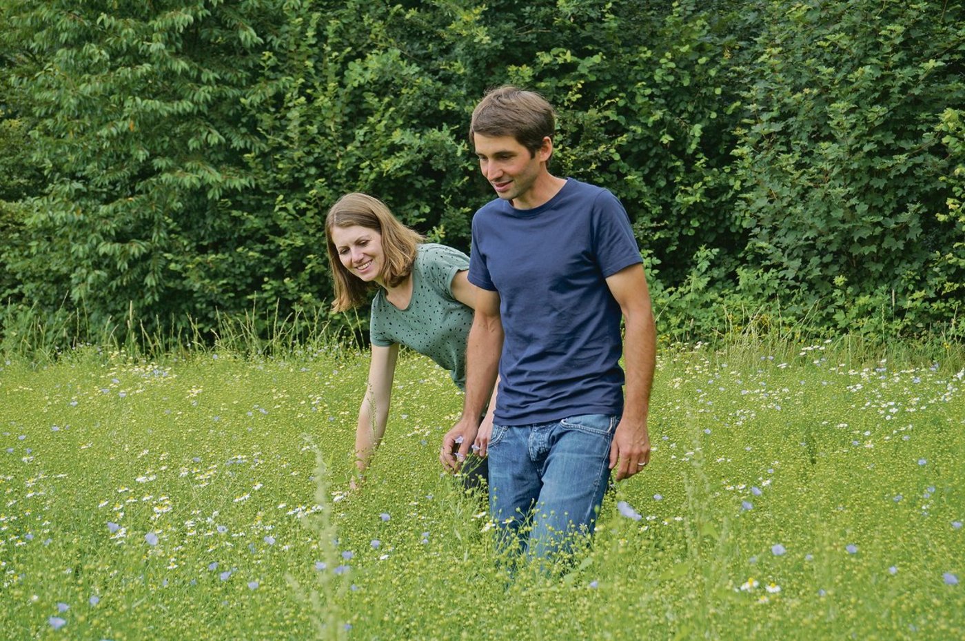 Anja und Reto Widmer spazieren über ein Feld mit Öllein. Die beiden bewirtschaften ihren gemeinsamen Biohof in Heimiswil seit 2016. Seither haben sie den Betrieb schrittweise weiterentwickelt und vielseitiger gemacht.(Bild Deborah Rentsch)