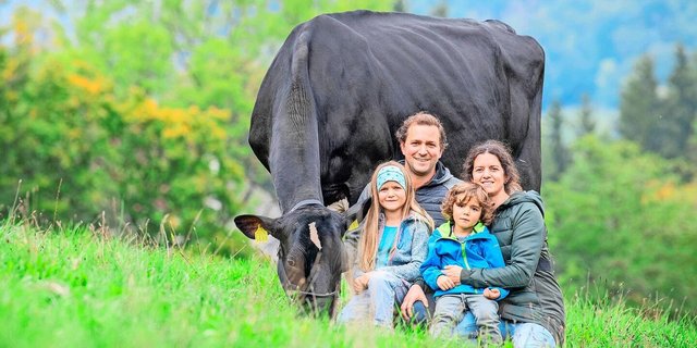 Fabian und Céline Dettwiler mit den Kindern Lynn und Ryan. Am Halfter ihre Stammkuh GranFaline Atwood Hailey VG 89 (Euter EX-91).